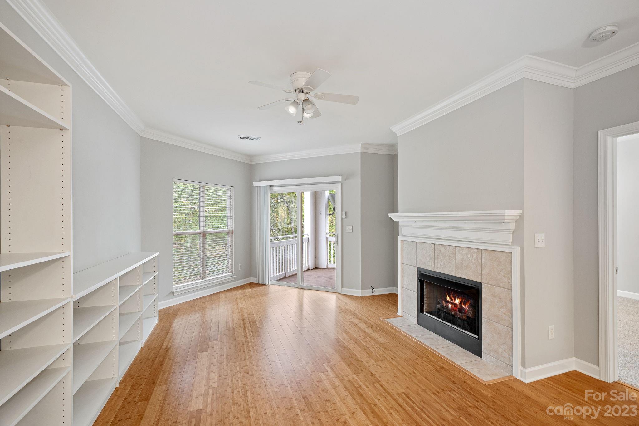 747 Peninsula Drive Davidson, NC 28036 - Photo 22 of 31 a view of a livingroom with wooden floor a fireplace and a window
