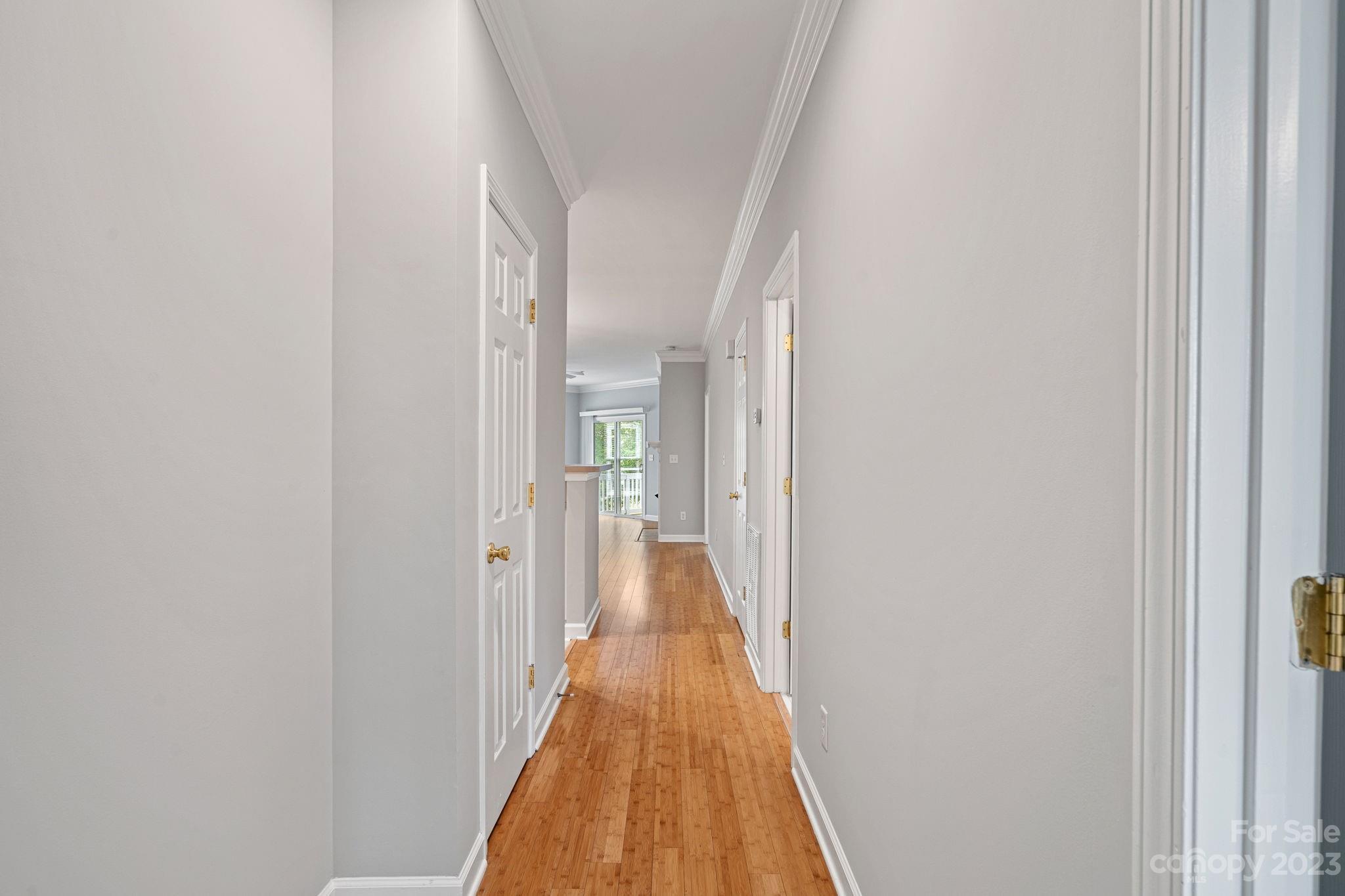 747 Peninsula Drive Davidson, NC 28036 - Photo 6 of 31 a view of a hallway with wooden floor and staircase