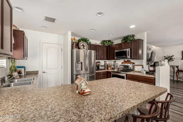 a kitchen with sink cabinets and stainless steel appliances