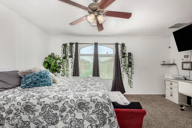 a bed room with a bed and a television