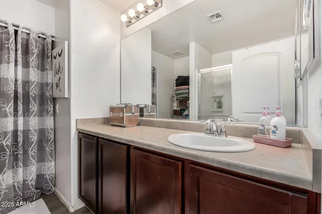 a bathroom with double vanity sinks and a mirror