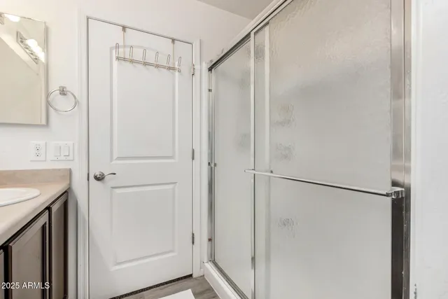 a bathroom with a shower and a sink