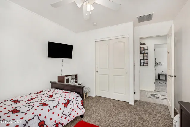 a bedroom with a bed and a flat screen tv