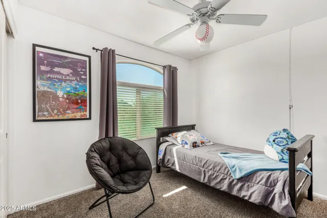 a bedroom with a bed and window