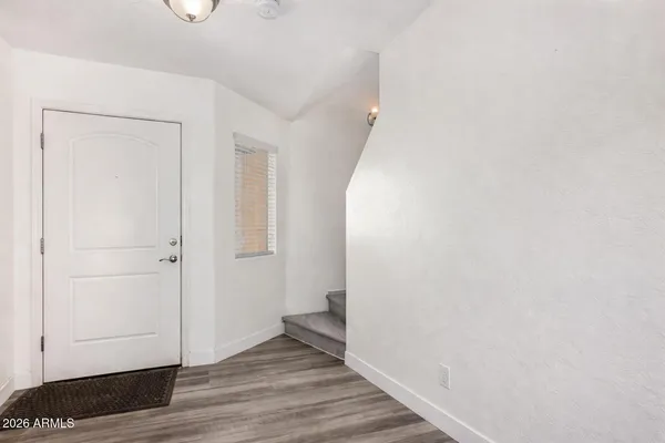 a kitchen with stainless steel appliances granite countertop a refrigerator a sink a stove and microwave