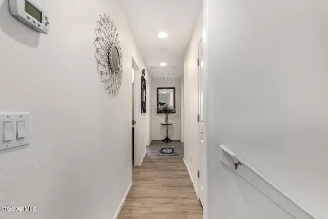 a view of a hallway with wooden floor and staircase