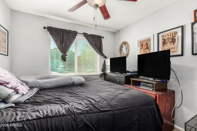 a bedroom with a bed and a flat screen tv