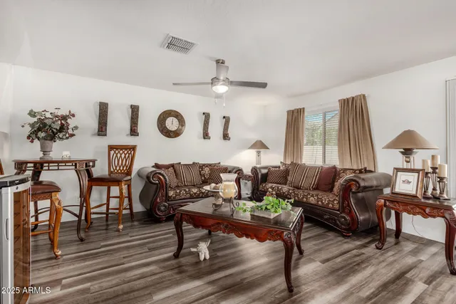a living room with furniture and wooden floor