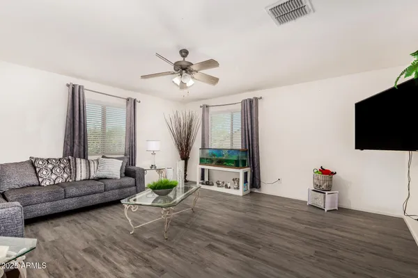 a living room with furniture fireplace and a large window