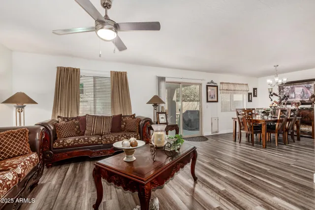 a living room with furniture and a wooden floor