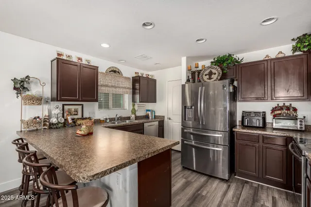 a kitchen with stainless steel appliances granite countertop a sink refrigerator and microwave
