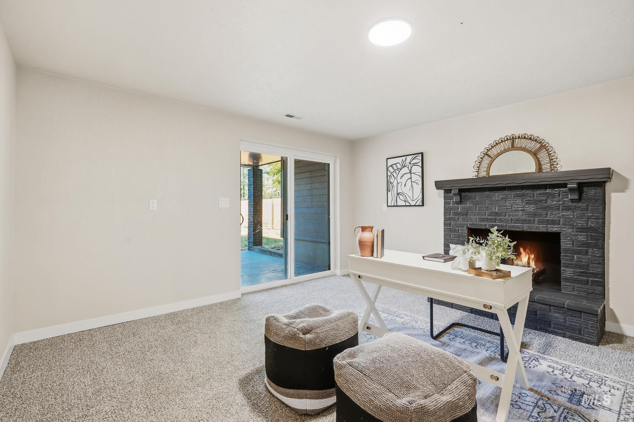 1990 Panama Street Boise, ID 83705 - Photo 29 of 50 Carpeted room with a black brick fireplace featuring a dark wood mantel