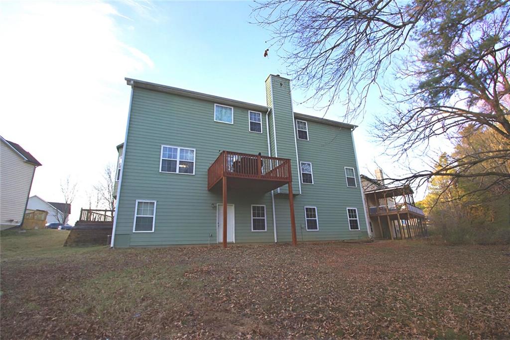 6074 Locklear Way Douglasville, GA 30134 - Photo 12 of 12 a view of a house with a yard and large tree