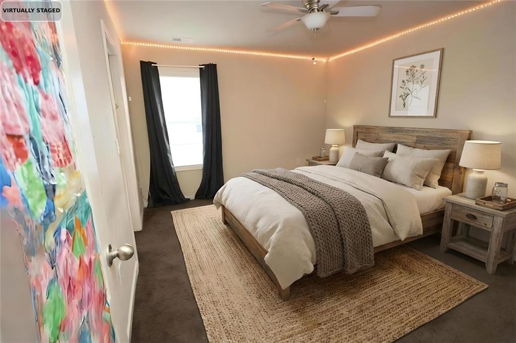 6074 Locklear Way Douglasville, GA 30134 - Photo 2 of 12 a bedroom with a bed and a painting on the wall