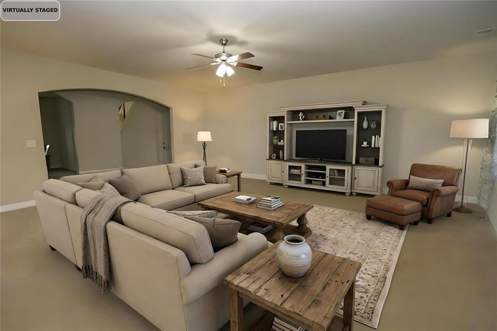 6074 Locklear Way Douglasville, GA 30134 - Photo 3 of 12 a living room with furniture a flat screen tv and kitchen view