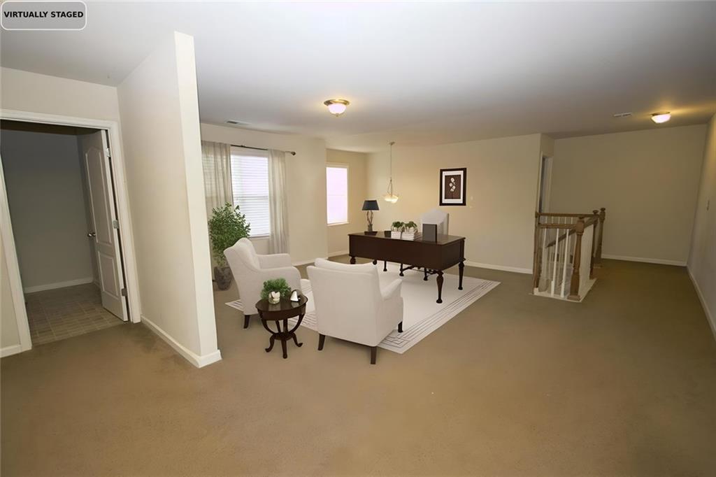 6074 Locklear Way Douglasville, GA 30134 - Photo 7 of 12 a living room with furniture and a table