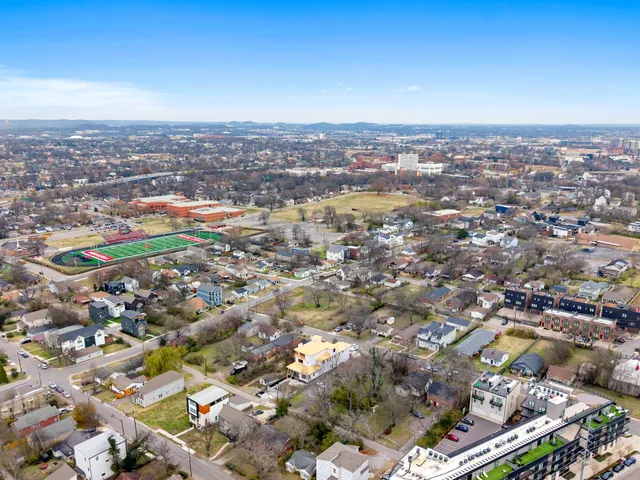 an aerial view of residential houses with city view