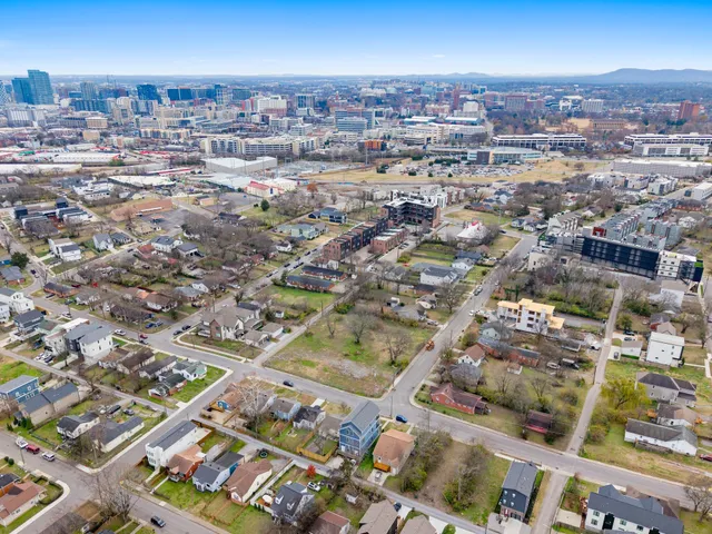 an aerial view of residential houses with city view