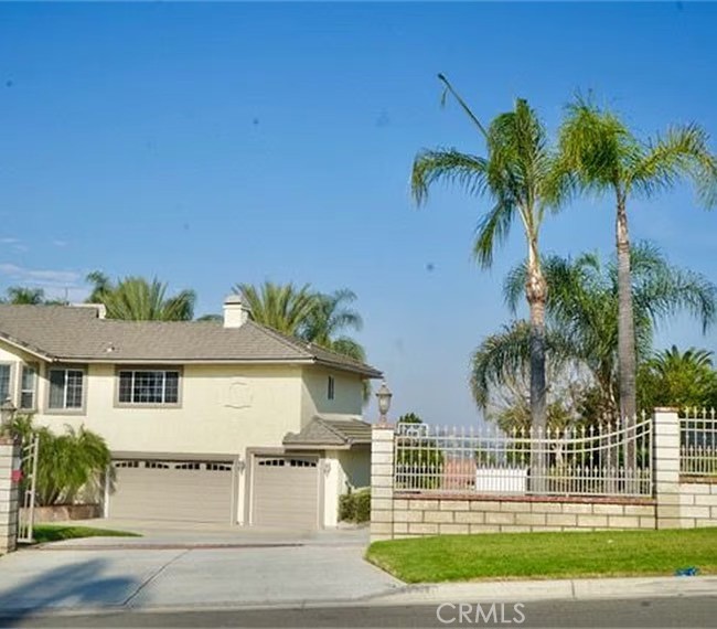 front view of house with a yard and potted plants