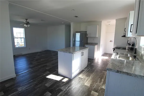 a kitchen with granite countertop a sink and a window