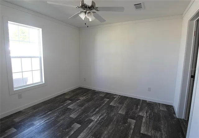 a bathroom with a granite countertop sink a toilet and a mirror