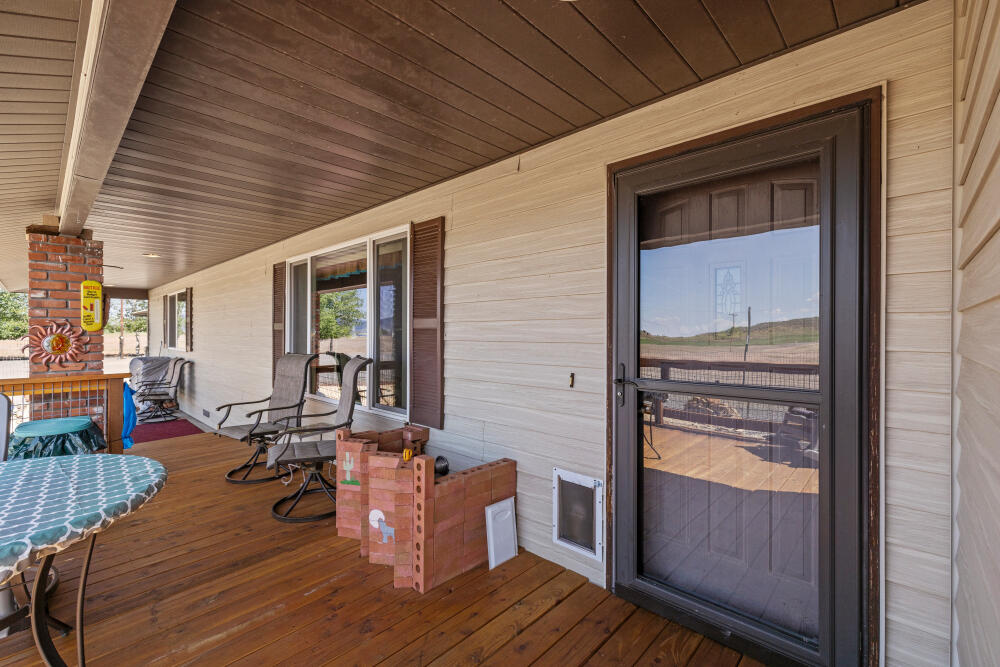 891 Cross Road Klamath Falls, OR 97603 - Photo 14 of 66 a view of a balcony with chairs and wooden floor