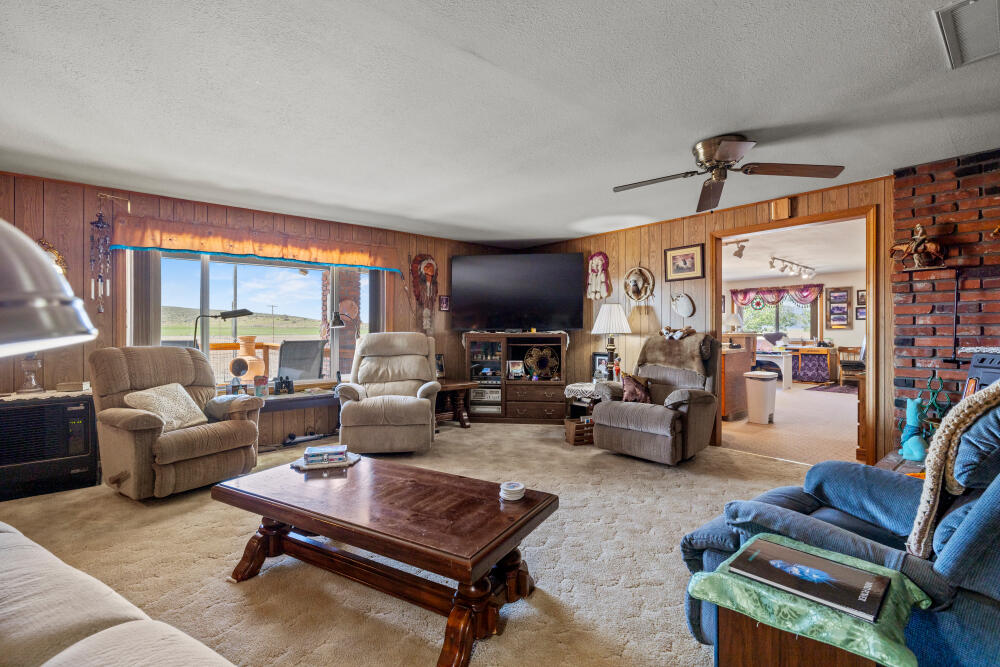 891 Cross Road Klamath Falls, OR 97603 - Photo 30 of 66 a living room with furniture and a flat screen tv