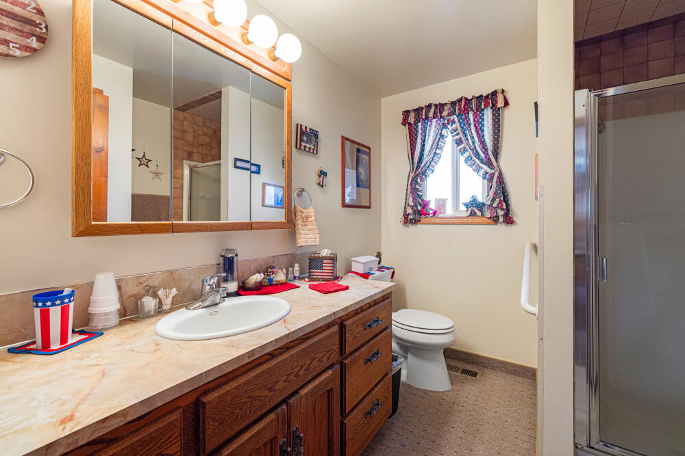 891 Cross Road Klamath Falls, OR 97603 - Photo 49 of 66 a bathroom with a sink vanity mirror and toilet