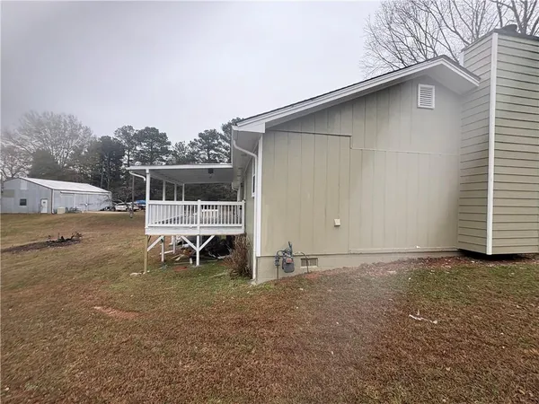 a backyard of a house with table and chairs