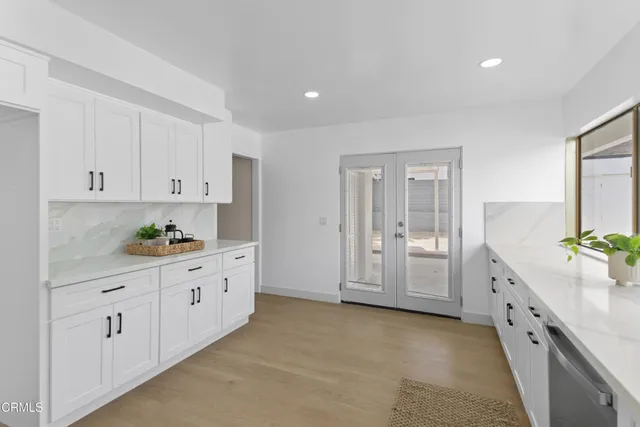 a kitchen with granite countertop a sink and cabinets