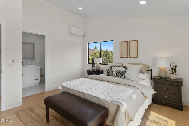 a bedroom with a bed and wooden floor