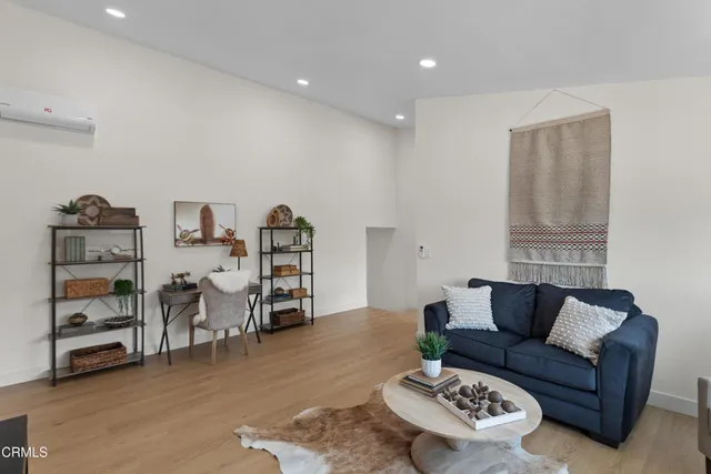 a living room with furniture and wooden floor
