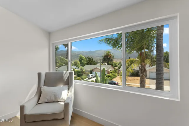 a outdoor living room with a couch and a large window