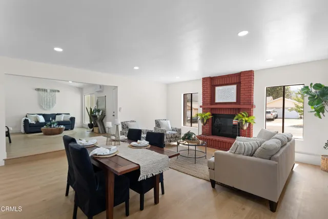 a living room with fireplace furniture and a wooden floor