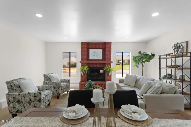 a living room with furniture potted plant and a window