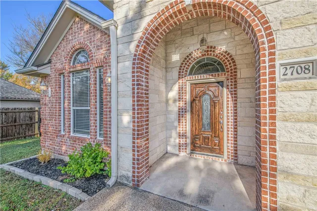 a view of a brick house with a large windows