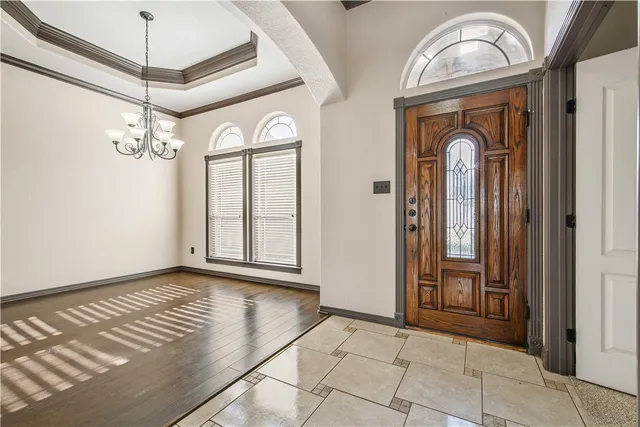 a view of a entryway door with a chandelier