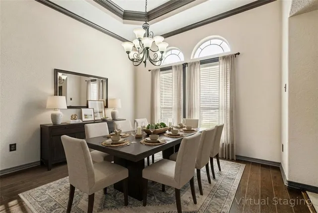 a view of a dining room with furniture a chandelier and wooden floor