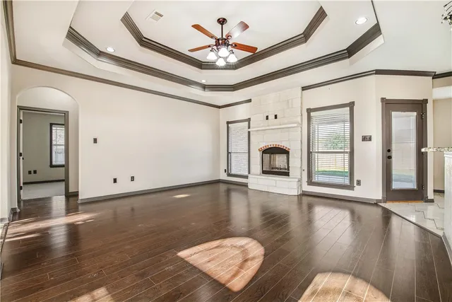 a view of a livingroom with wooden floor and a ceiling fan