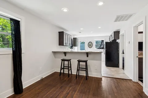 a kitchen with granite countertop a sink and a stove