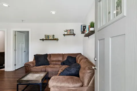 a living room with furniture and a wooden floor