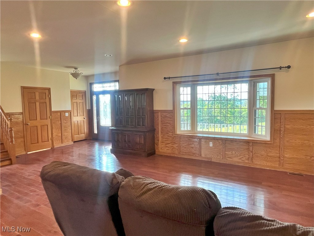 17583 Davis Ridge Road Caldwell, OH 43724 - Photo 17 of 42 Living area featuring a wainscoted wall, wood-type flooring, recessed lighting, and stairs