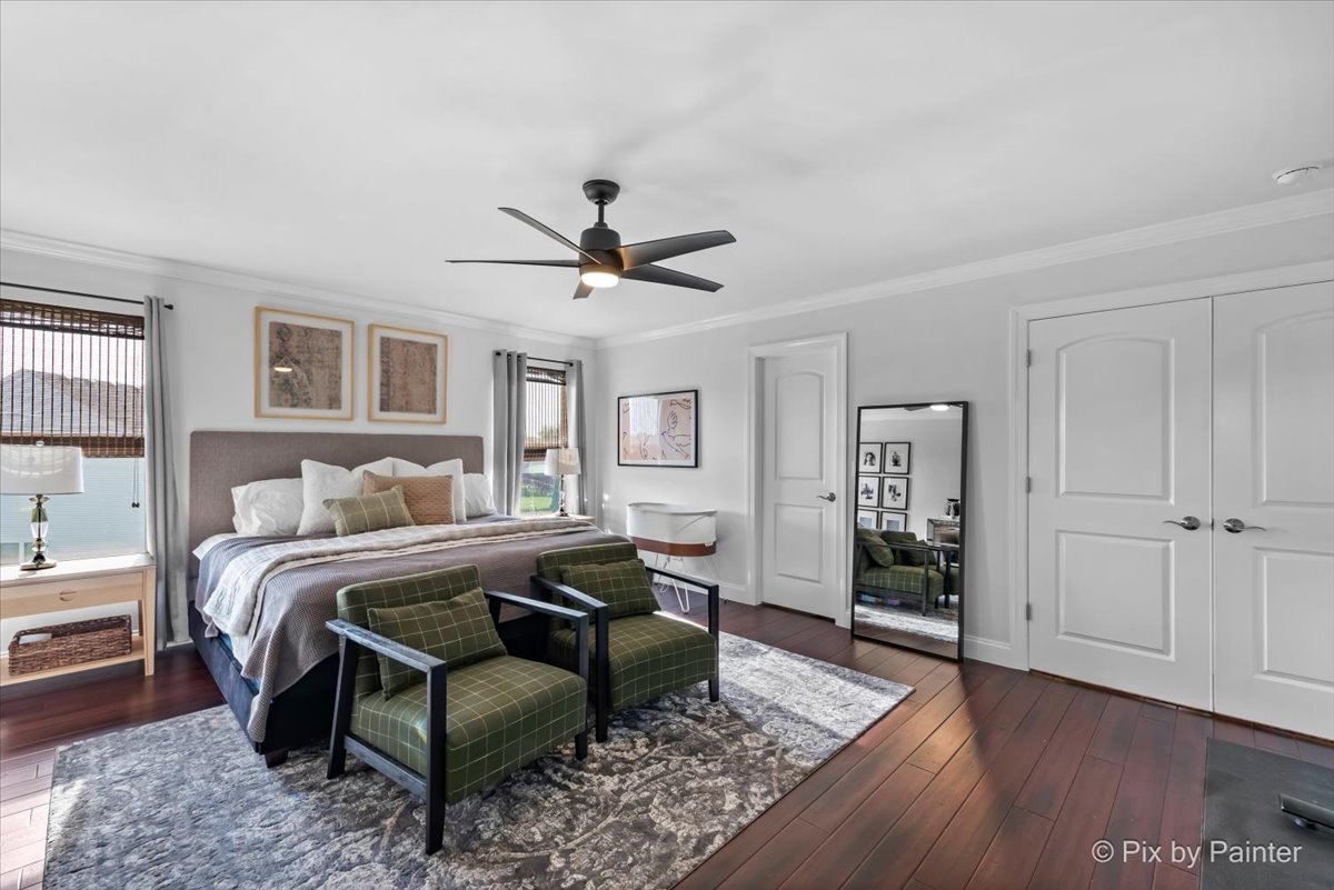 3503 High Ridge Road Carpentersville, IL 60110 - Photo 18 of 29 a spacious bedroom with a bed a dresser and wooden floor