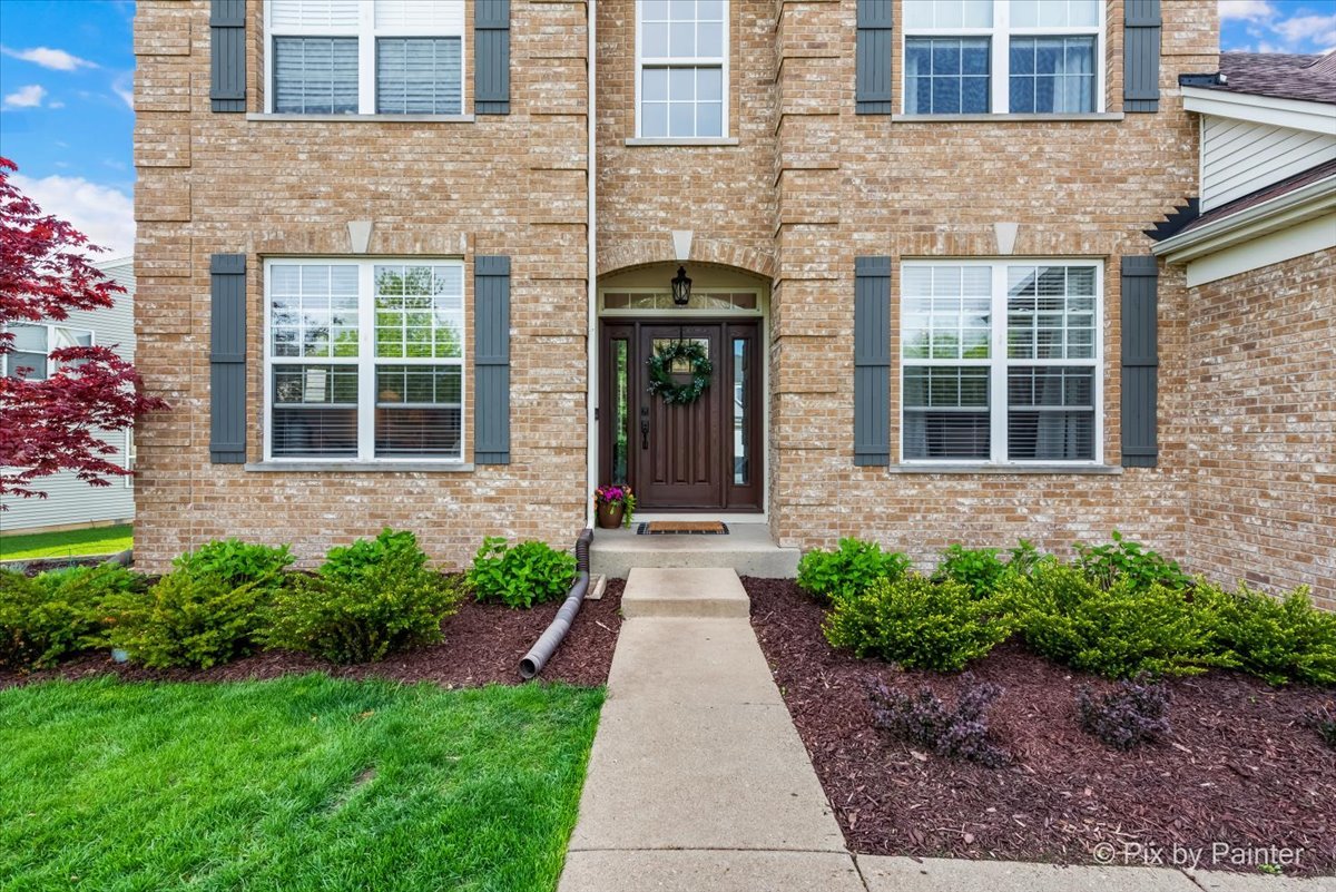 3503 High Ridge Road Carpentersville, IL 60110 - Photo 2 of 29 a front view of a brick house with a yard