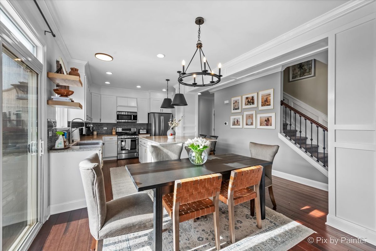 3503 High Ridge Road Carpentersville, IL 60110 - Photo 6 of 29 a dining room with furniture a chandelier and wooden floor