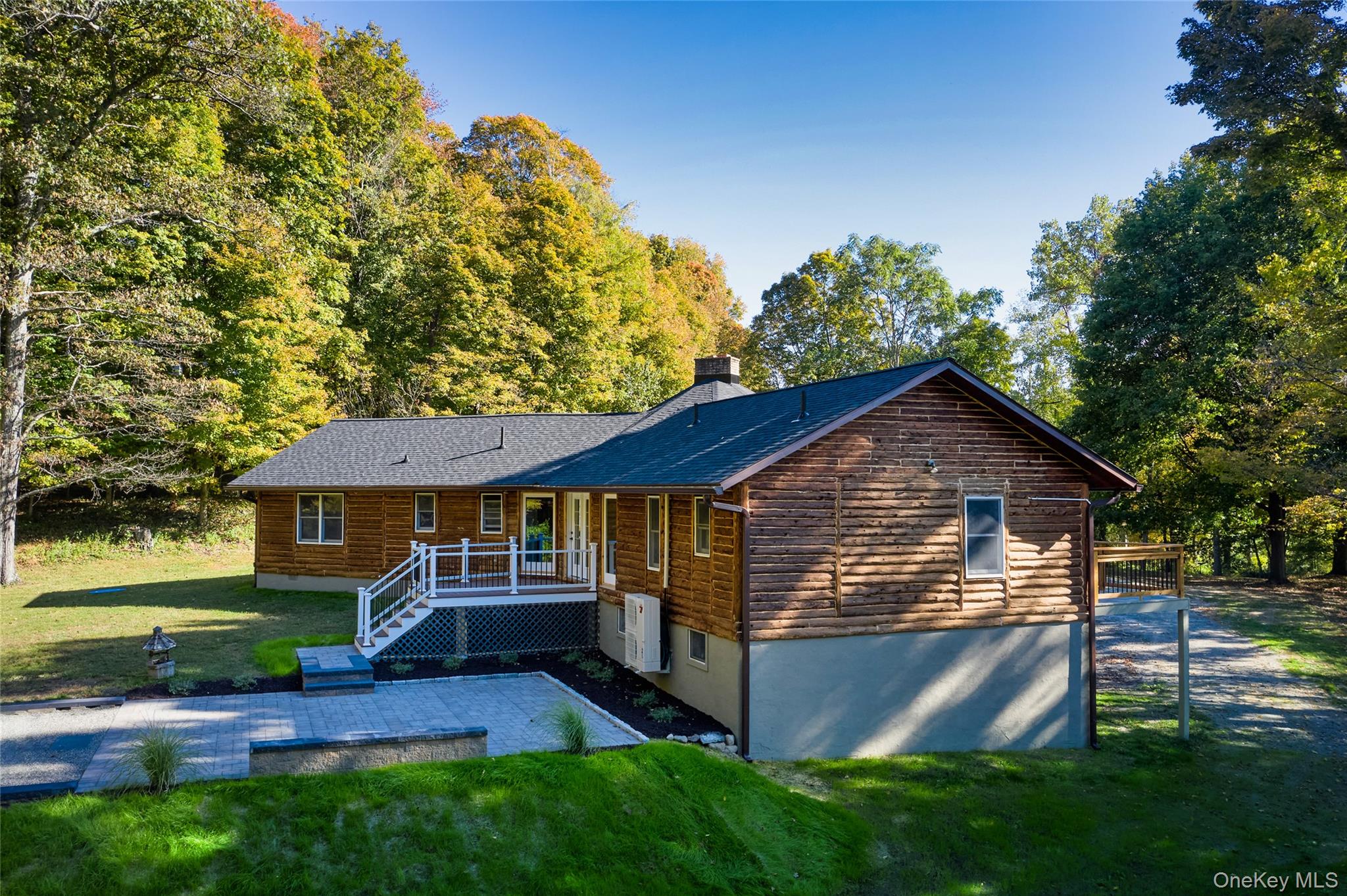 568 Oak Summit Road Millbrook, NY 12545 - Photo 46 of 50 Rustic home featuring a front lawn, a chimney, and a deck