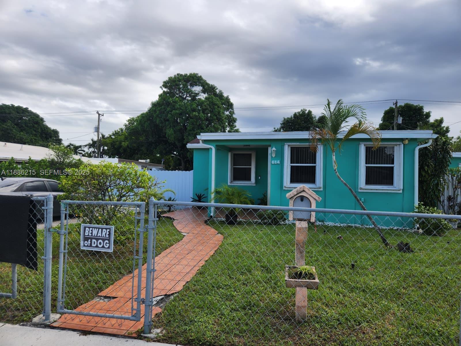 614 East 56th Street Hialeah, FL 33013 - Photo 1 of 78 front view of a house with a yard