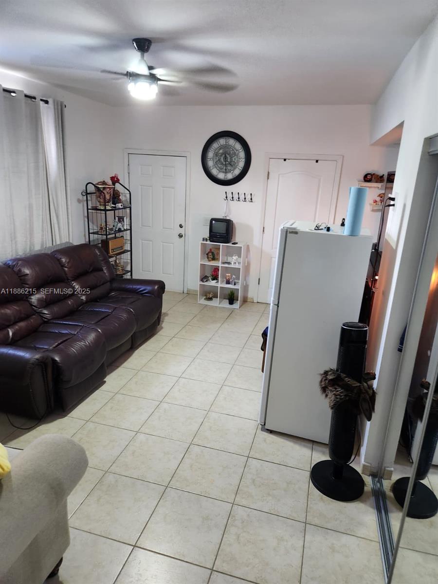614 East 56th Street Hialeah, FL 33013 - Photo 16 of 78 a living room with furniture and a clock