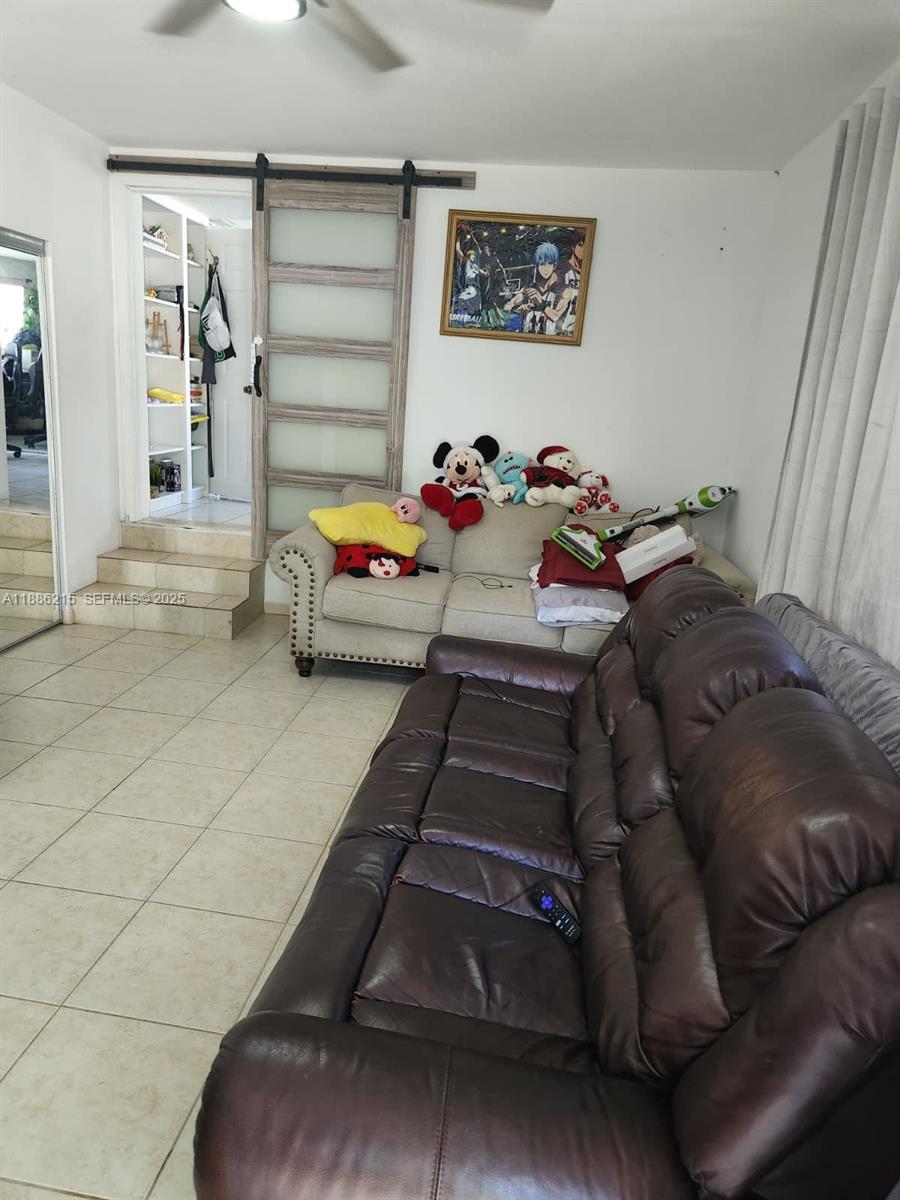 614 East 56th Street Hialeah, FL 33013 - Photo 18 of 78 a living room with furniture and a baby crib