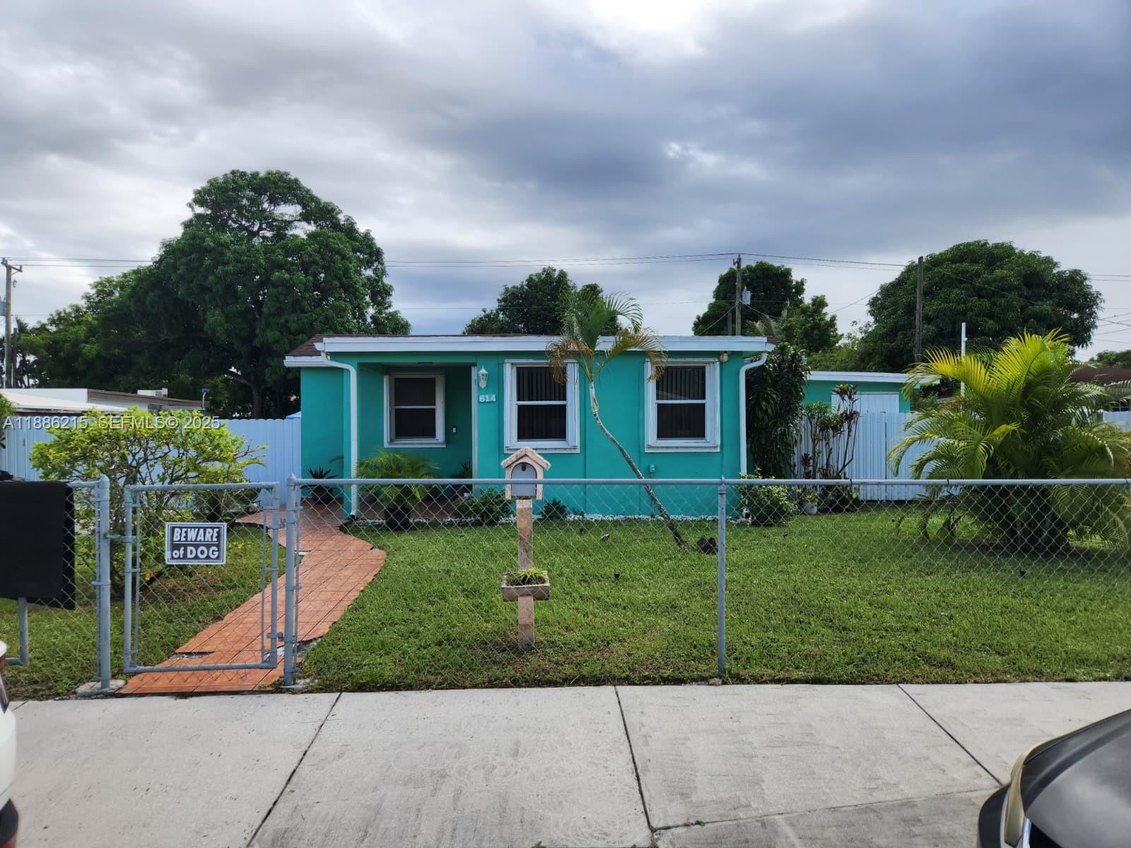 614 East 56th Street Hialeah, FL 33013 - Photo 2 of 78 front view of a house with a yard